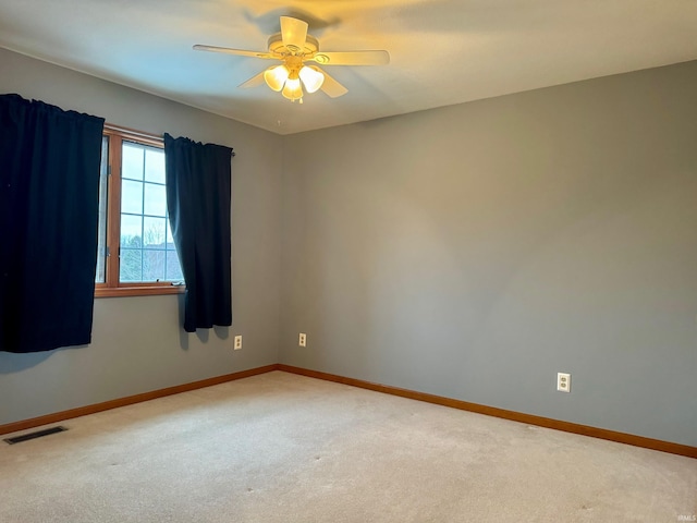 spare room featuring carpet and ceiling fan