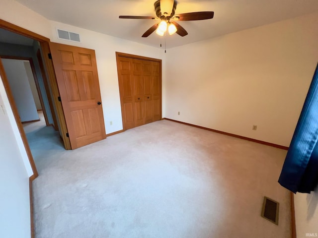 unfurnished bedroom featuring ceiling fan and light colored carpet