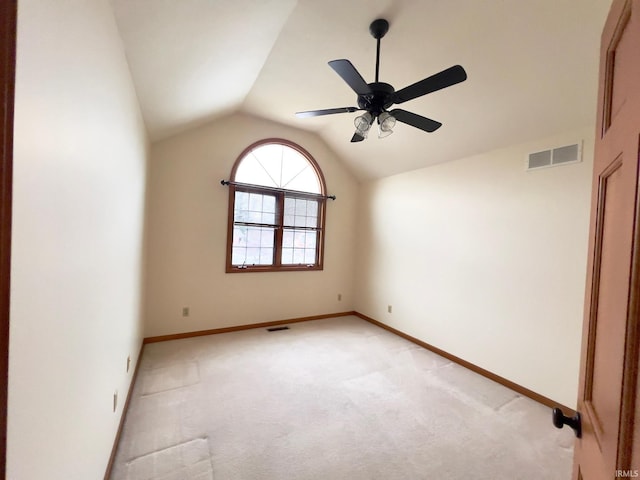 carpeted spare room with ceiling fan and lofted ceiling