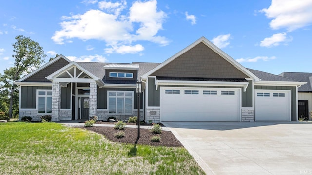 craftsman house with a front yard and a garage