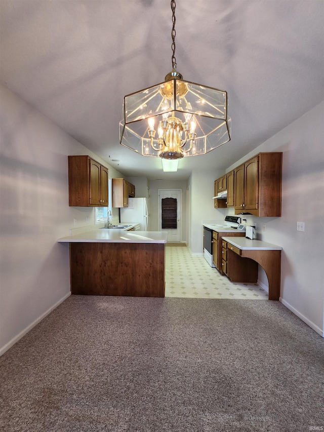 kitchen with pendant lighting, white appliances, sink, kitchen peninsula, and a chandelier