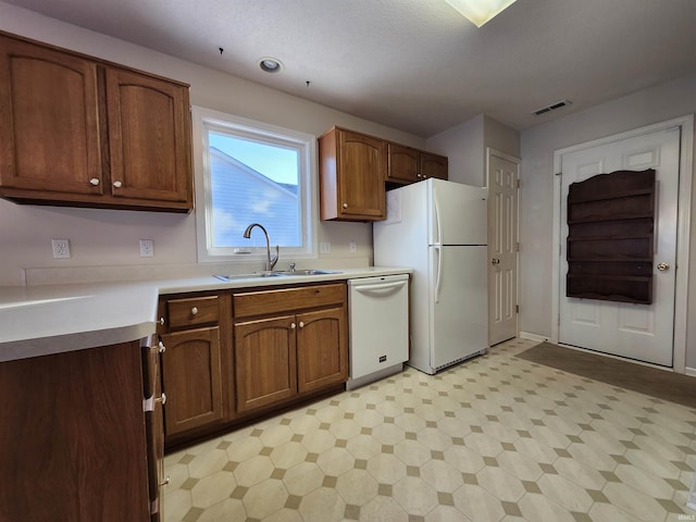 kitchen with sink and white appliances