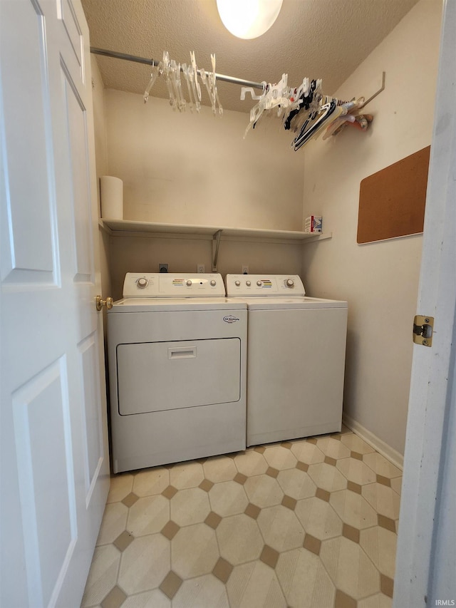 washroom featuring washer and dryer and a textured ceiling