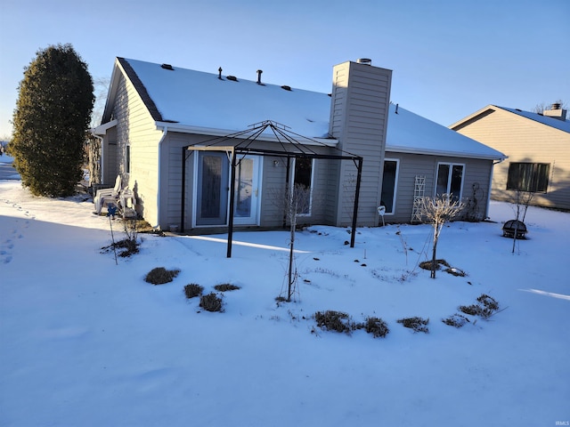 view of snow covered rear of property