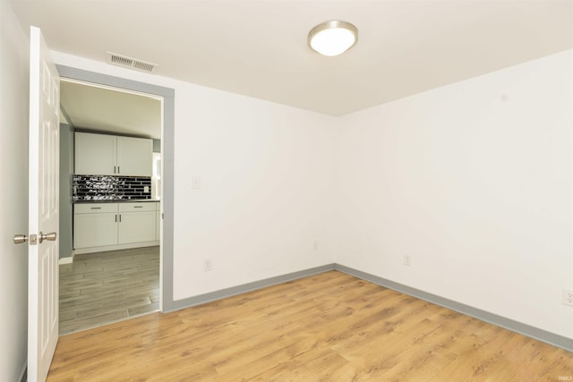 empty room with light hardwood / wood-style floors