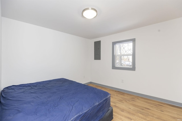 bedroom featuring light hardwood / wood-style floors and electric panel