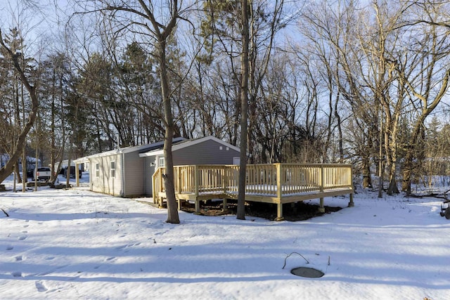 snow covered property with a wooden deck