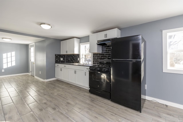 kitchen featuring black appliances, white cabinets, decorative backsplash, and light hardwood / wood-style floors