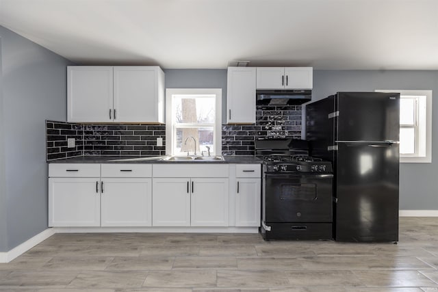 kitchen with sink, white cabinetry, and black appliances