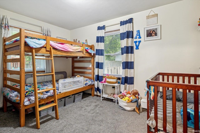 bedroom with carpet and a crib