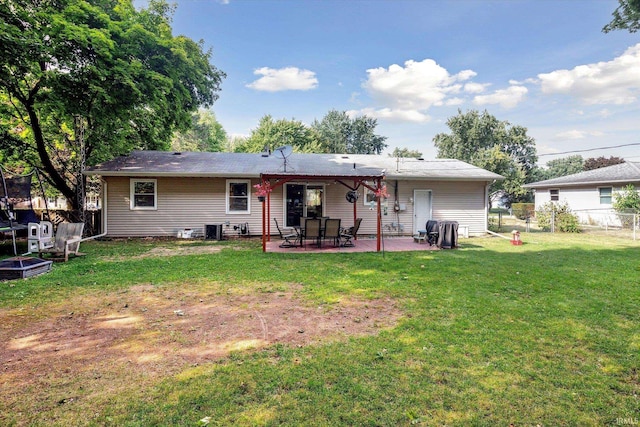 rear view of property featuring a patio area, central AC unit, and a lawn