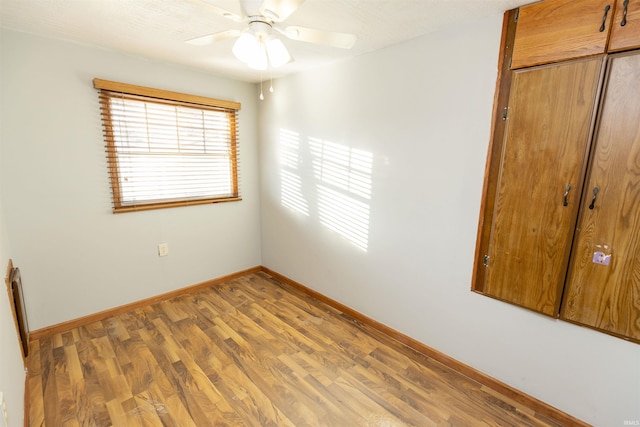 spare room featuring ceiling fan and wood-type flooring