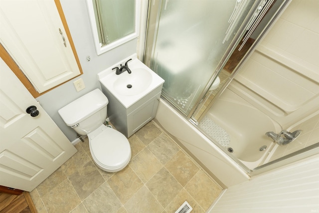 full bathroom featuring toilet, enclosed tub / shower combo, and vanity