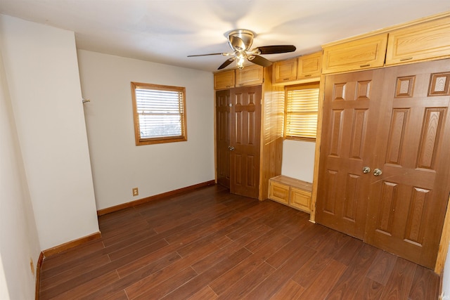 unfurnished bedroom featuring ceiling fan and dark hardwood / wood-style flooring