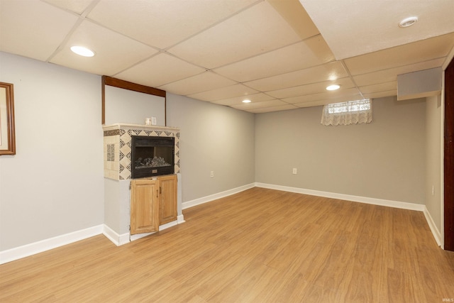 basement featuring hardwood / wood-style flooring and a drop ceiling