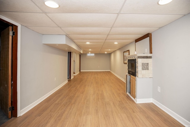 basement with light hardwood / wood-style floors and a drop ceiling