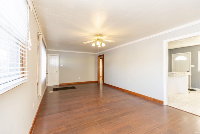 spare room with ceiling fan, crown molding, and hardwood / wood-style flooring