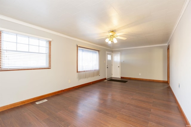 spare room with ceiling fan, crown molding, and dark hardwood / wood-style floors