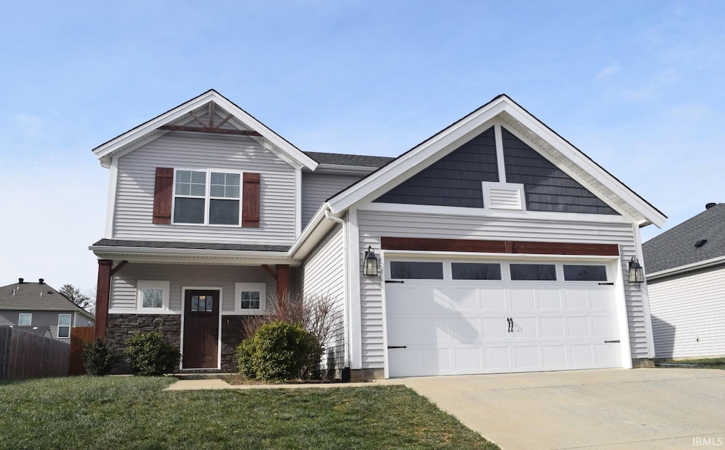 craftsman-style home featuring a front yard and a garage