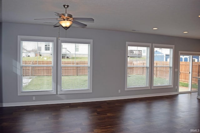 empty room with dark wood-type flooring and ceiling fan