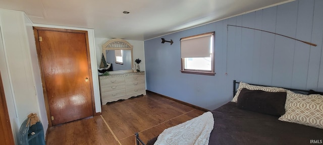 bedroom with dark hardwood / wood-style floors