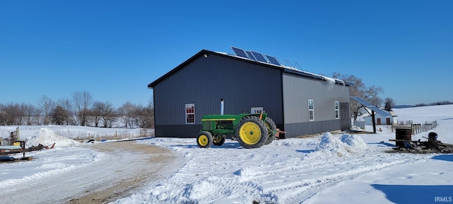 view of snow covered exterior featuring an outdoor structure