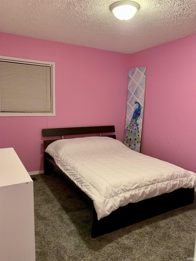 carpeted bedroom featuring a textured ceiling