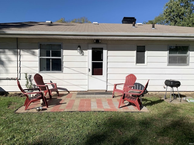 back of property featuring a yard and a patio