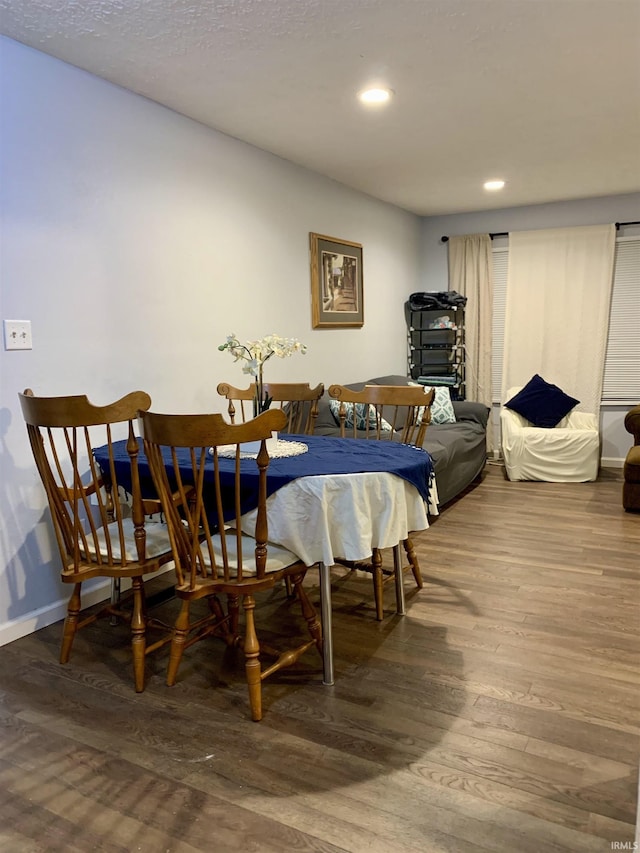 dining space with wood-type flooring