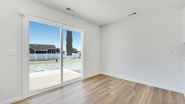 unfurnished room with light hardwood / wood-style flooring