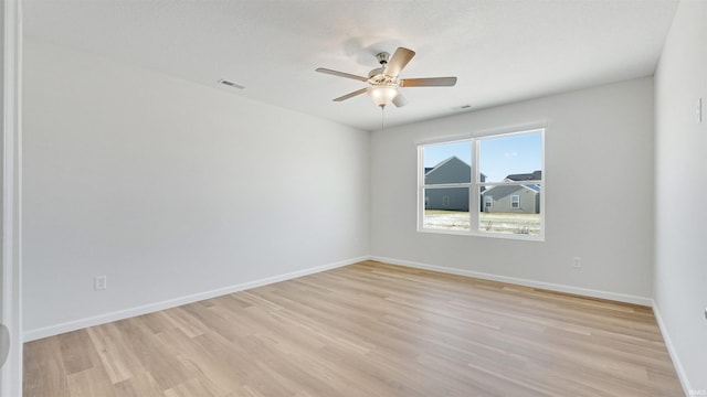 spare room featuring ceiling fan and light hardwood / wood-style floors