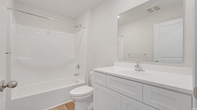 full bathroom featuring toilet, tub / shower combination, hardwood / wood-style floors, and vanity