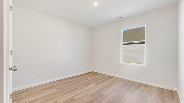 spare room featuring light hardwood / wood-style floors