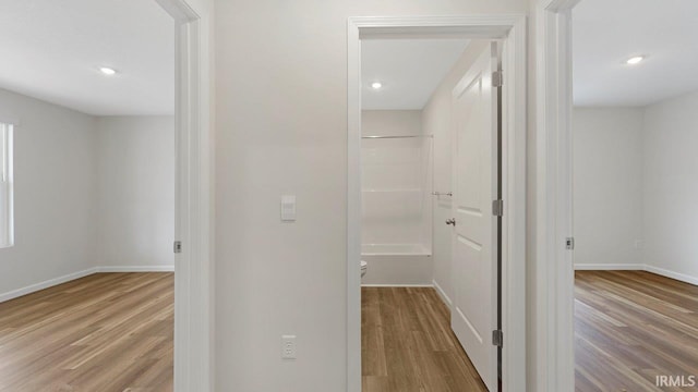 corridor with light hardwood / wood-style floors