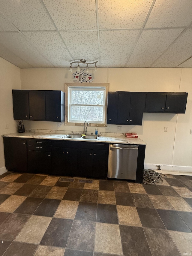 kitchen featuring sink, dishwasher, and a paneled ceiling