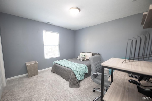 bedroom featuring light carpet