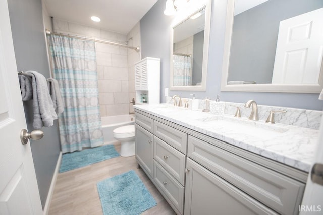 full bathroom featuring toilet, shower / bathtub combination with curtain, hardwood / wood-style flooring, and vanity