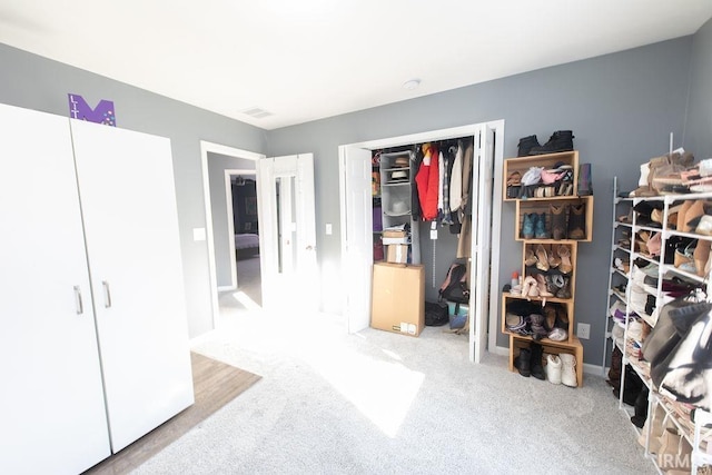 bedroom featuring a closet and light colored carpet