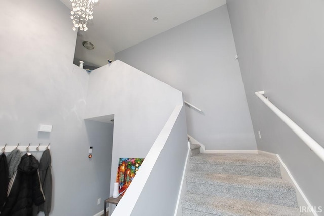 stairway featuring an inviting chandelier