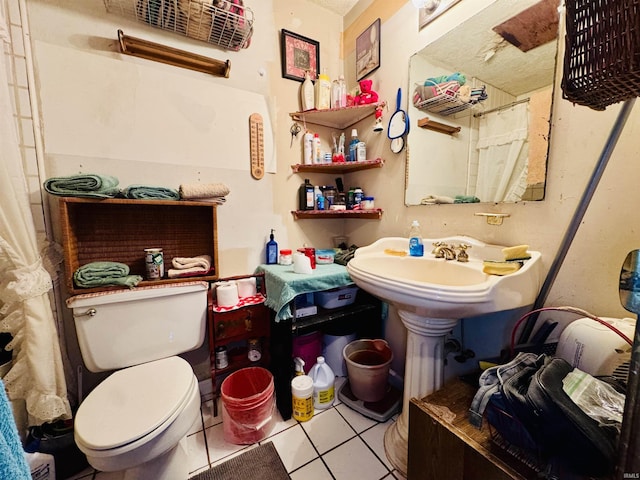 bathroom featuring toilet, a shower with curtain, and tile patterned flooring