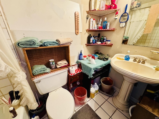 bathroom with toilet and tile patterned flooring