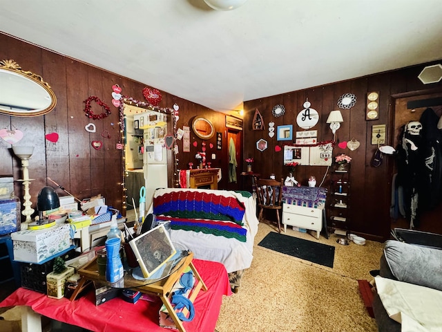 bedroom featuring wood walls and carpet flooring