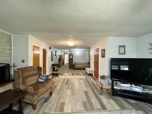 living room with a textured ceiling and hardwood / wood-style floors