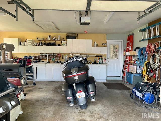 garage featuring a workshop area and a garage door opener