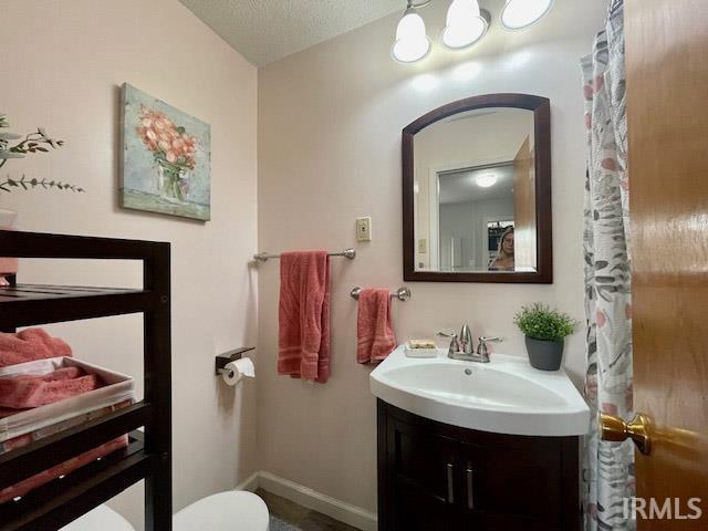 bathroom featuring a textured ceiling and vanity