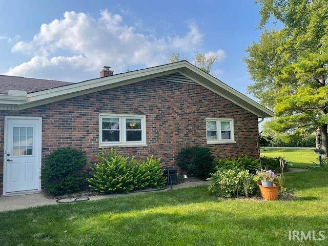 view of side of home featuring a lawn