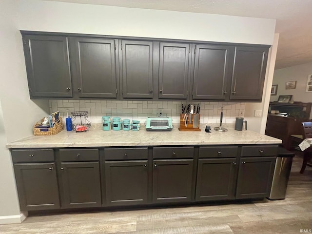 kitchen featuring backsplash and light hardwood / wood-style floors