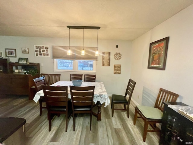 dining area featuring wood-type flooring