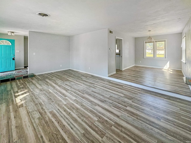 unfurnished living room with light hardwood / wood-style flooring