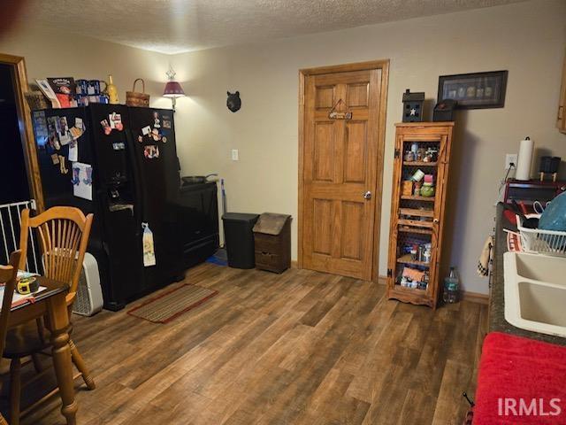 misc room with dark wood-type flooring, sink, and a textured ceiling